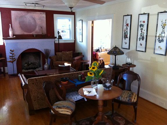 Living room with furniture, red wall around fireplace has been painted over to match the room.