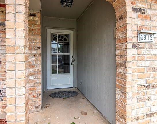 Bricks accent the entry to the front door.