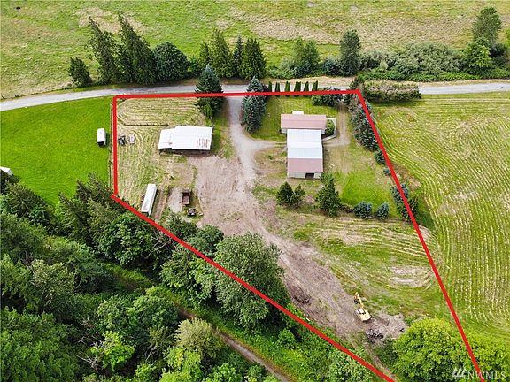 Approximate outline of property 2.39 acres with manufactured home, 2 large shops and partially fenced pasture.