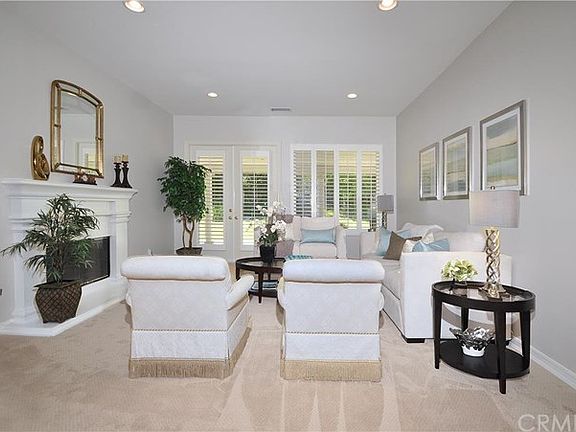 The spacious Living Room features new designer paint and carpet, plantation shutters and a lovely fi