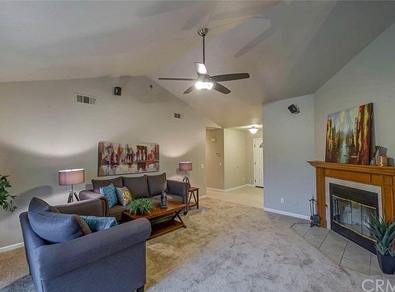 family room with built in speakers and fireplace.