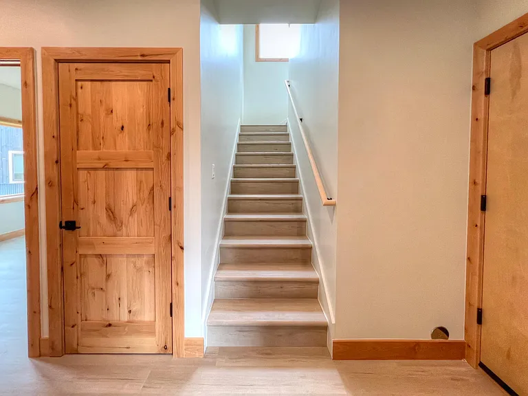 Entry. Garage access to the right and jacket closet to the left. Further left is the entry to the primary bedroom.