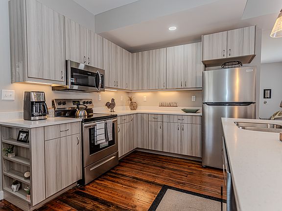 Kitchen with custom cabinets & brand new stainless steel appliances