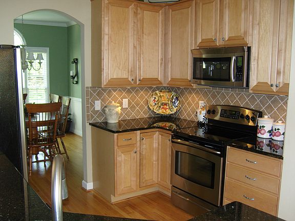 In the kitchen you will find granite counter tops with a tile backsplash. New stainless steel appliances and under cabinet lighting make this kitchen ideal. This kitchen also features a eat on bar for