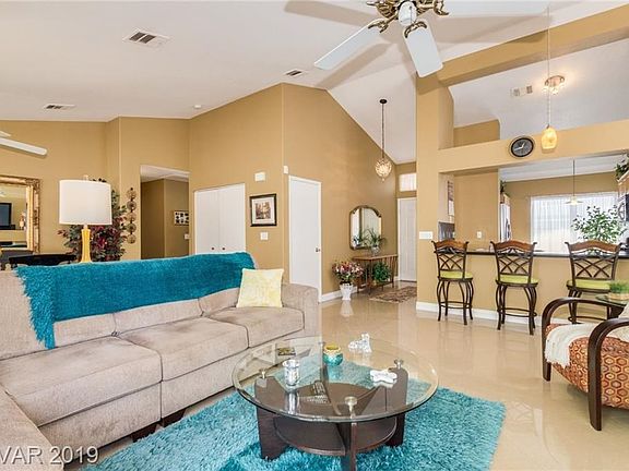Living room adjoins the kitchen and has a ceiling fan and sliding doors to the back yard...