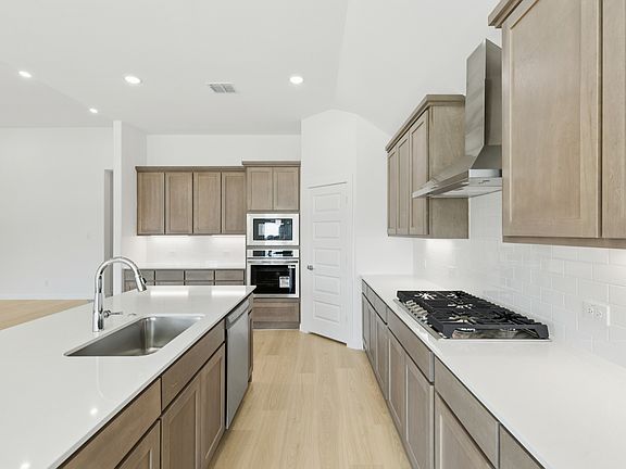 Kitchen in the Gilmour II home plan by Trophy Signature Homes - REPRESENTATIVE PHOTO
