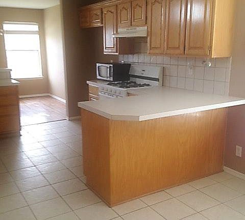 Lots of light and cabinets, open kitchen