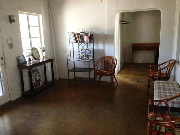 Living room area, concrete floors. (Front door on left) Breakfast nook straight ahead...3rd bdrm off this Nook to the left.