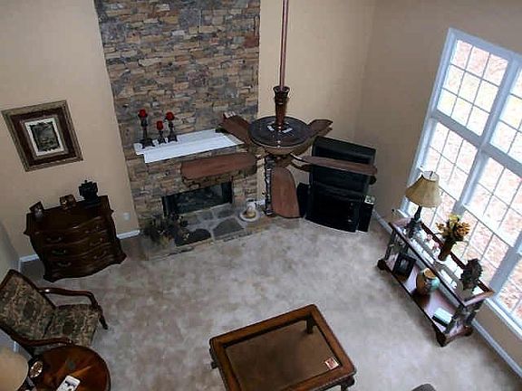 2 story Family Room w/ dramatic floor to ceiling stack stone fireplace