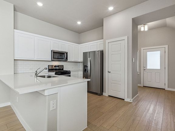 Kitchen in the Birch home plan by Trophy Signature Homes - REPRESENTATIVE PHOTO