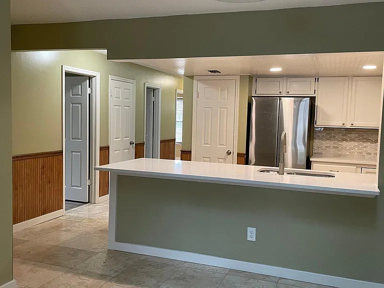 Newly remodeled open kitchen and great room space. Plenty of space for bar stools plus a dining table.