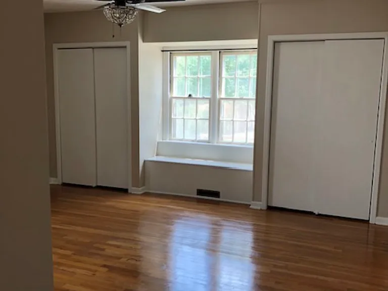 Large primary room with 3 closets, window bench with storage & ceiling fan/light