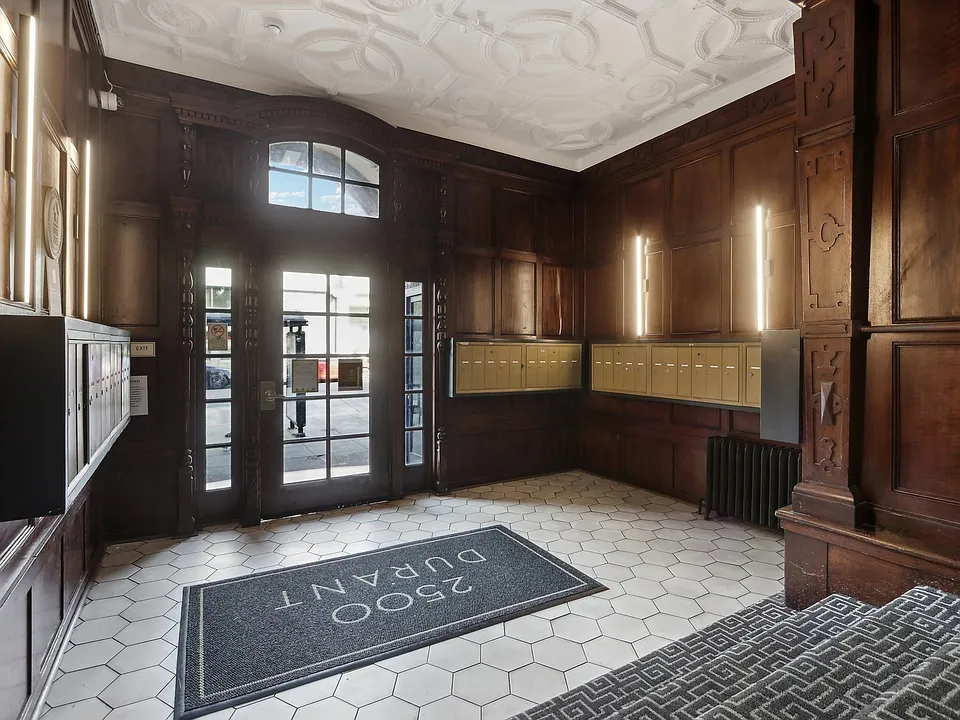 Grand entrance to a building, featuring a large wooden door with a glass window