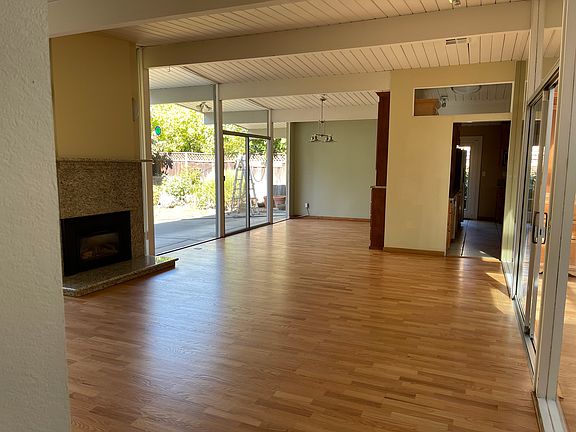 living and dining room, gas fireplace, built-in storage in the dining room.