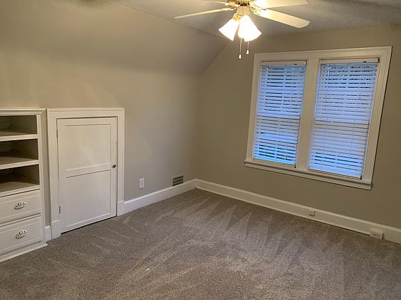 upstairs bedroom with storage, ceiling fan, wood blinds and new heating/ac unit