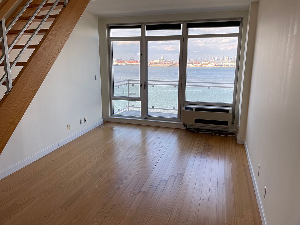 Living room and stairs go to the upstairs office/landing and entry door to the private roof deck. There is balcony access from the living room and master bedroom. The current tenant has a big couch under the stairs and TV on the opposite wall.