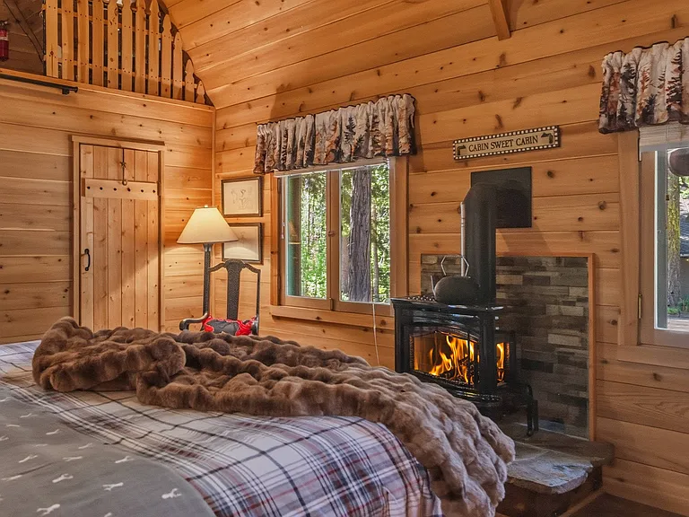 Bedroom 1: Primary Suite with Cal King, En-Suite Bathroom and thermostat controlled gas stove / fireplace.