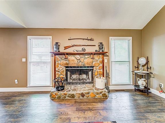 Image 3: Rustic Fireplace is faced with Stone from the Property