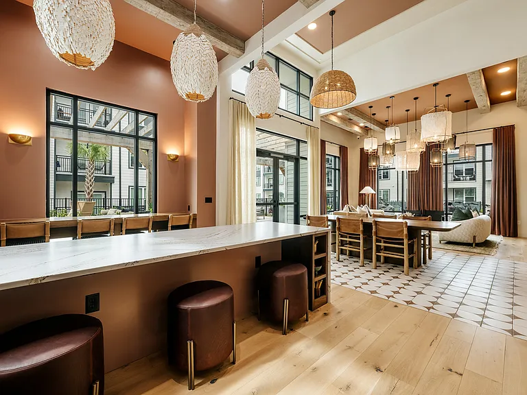 Stylish apartment maker's space with collaborative seating, modern finishes, and flexible areas for resident events and gatherings.