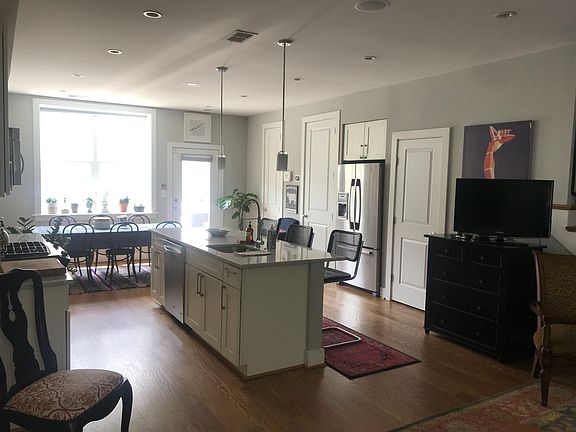 Back door walks out to 20 ft by 20 ft back private patio. First floor doors along right wall include storage access, mechanical closet and half bath. Kitchen includes stainless steel appliances, gas stove with 4 burners, dishwasher, dishwasher disposal,