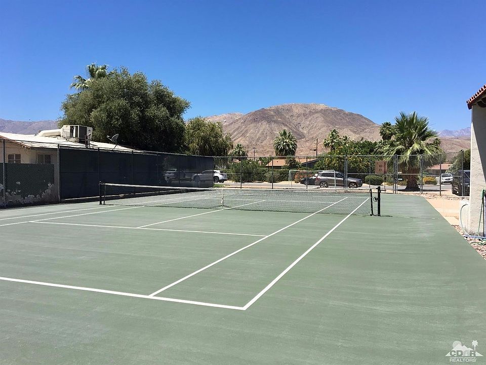 Western mountain view from back of private tennis court.
