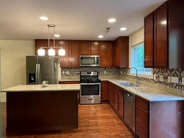 Updated Kitchen with Granite Countertops, Decorative Backsplash and All New Stainless Steel Appliances