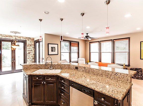Breakfast Bar open to family room. Gorgeous pendant lighting