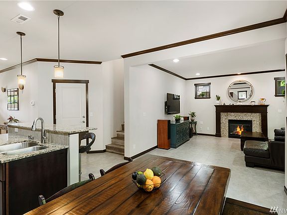 Looking towards the gas fireplace and stairs with no carpet.