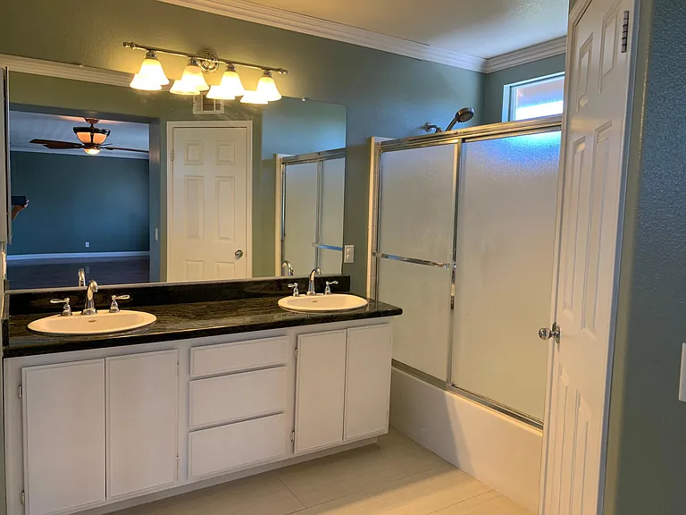 Very large master bedroom with double sinks.