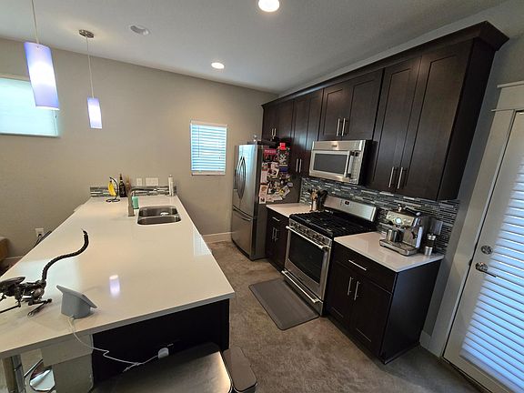 Kitchen with stainless steel appliances, garbage disposal, dishwasher and great lighting!