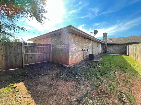 Exterior Backyard, fully fenced, shows entry through garage, and separate entry through living room