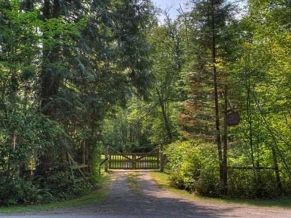 Welcome to "Twin Creeks" gated home at 27819 Issaquah-Fall City Rd. Enter this oasis to the tranquil and idyllic setting behind one of two electronic gates on the 4.25 acre property.