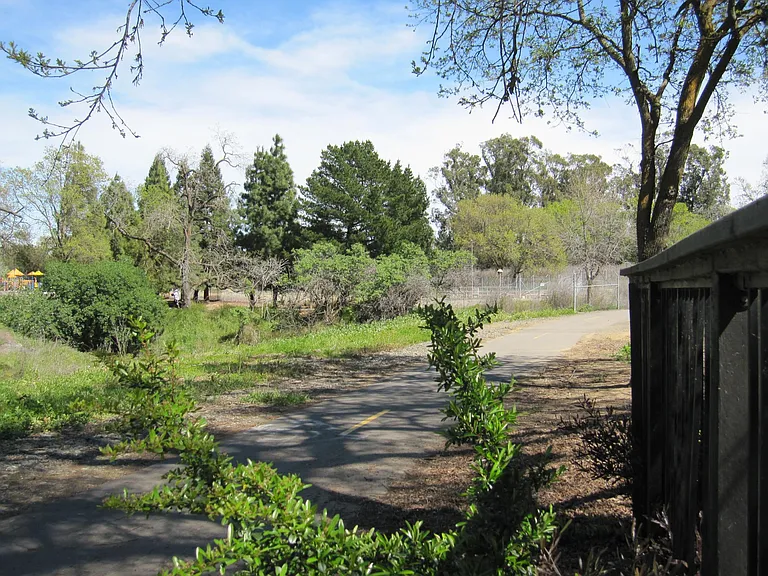Adjacent Alamo Creek nature trail just steps away from schools, park, play area.