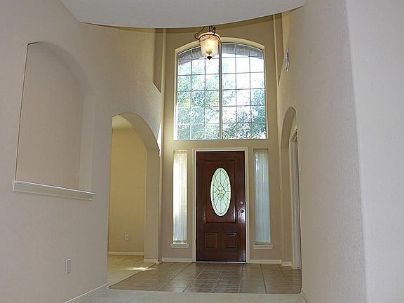 Inside, the two-story entry is a preview to the wide-open spaces embellished by Romanesque arches everywhere.