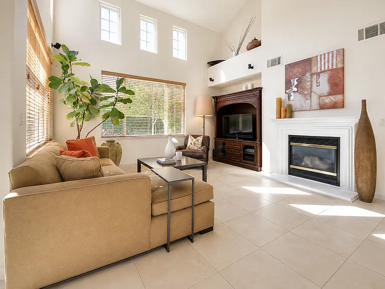 Bright, open family room with soaring ceilings and fireplace.