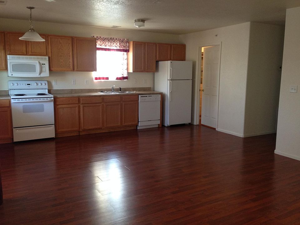Open floor plan includes kitchen and living area; cherry flo