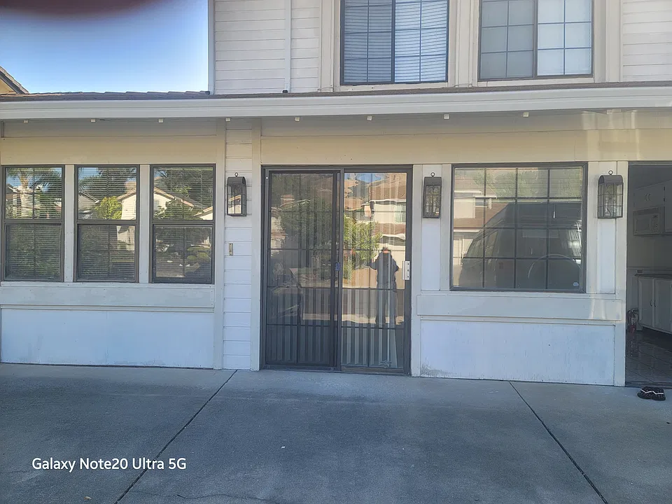 Front view of 2 bedroom, 1 bath unit (attached to main home) with one parking spot available in front of unit.
