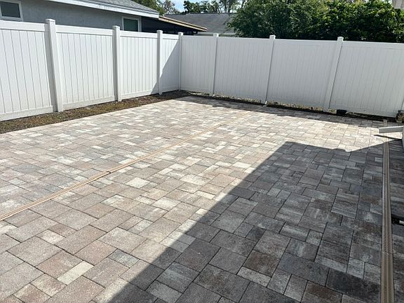PVC white fencing with pavers and grass border