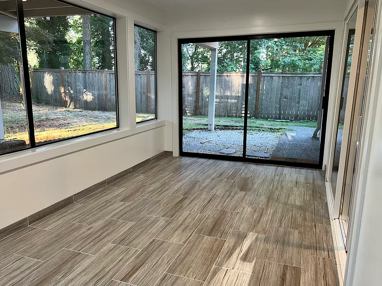 Enclosed sunroom offers versatile bonus space.