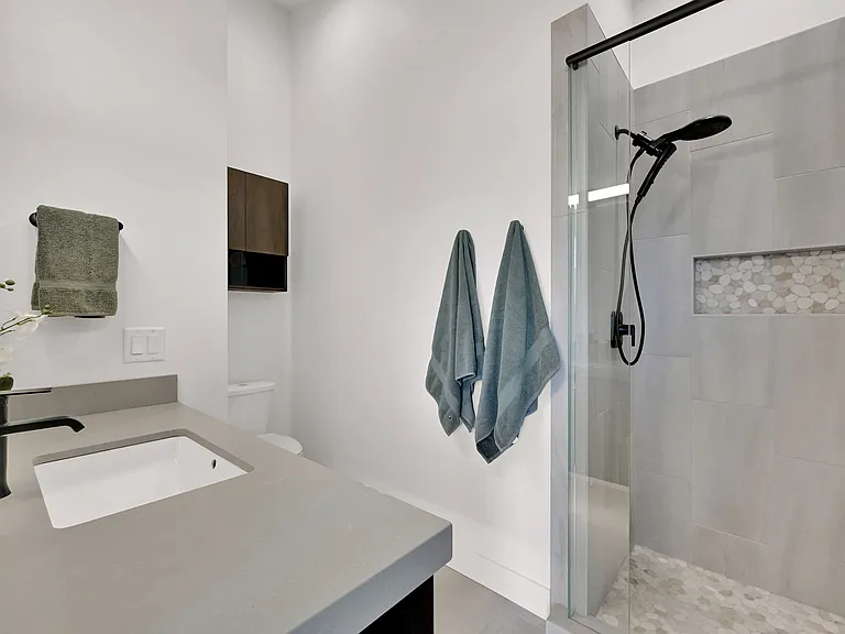 Master bathroom large walk in shower with built in shelf