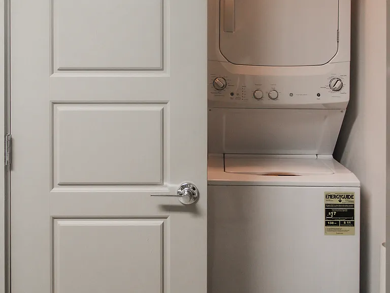 sStacked washer and dryer. Located in garage