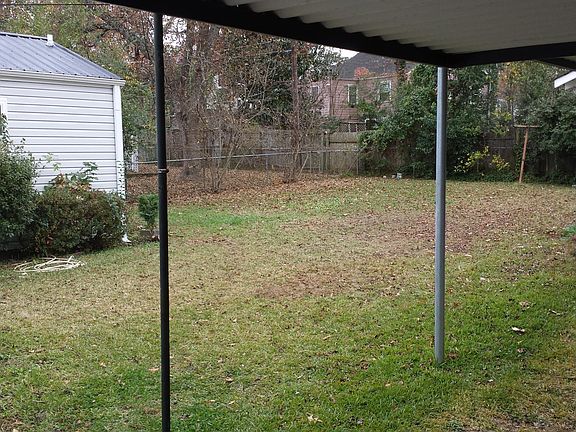 Fenced backyard with storage building