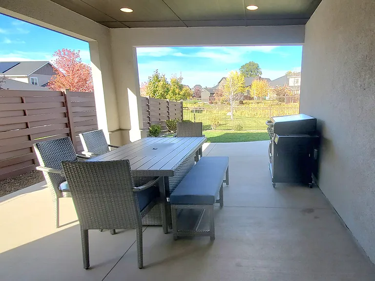 REAR COVERED PATIO WITH OVERHEAD DOWNLIGHTS.