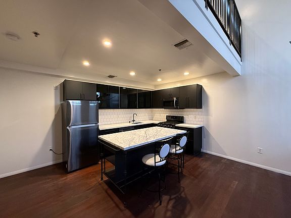 Gourmet upgraded kitchen with quartz countertops and stainless steel appliances