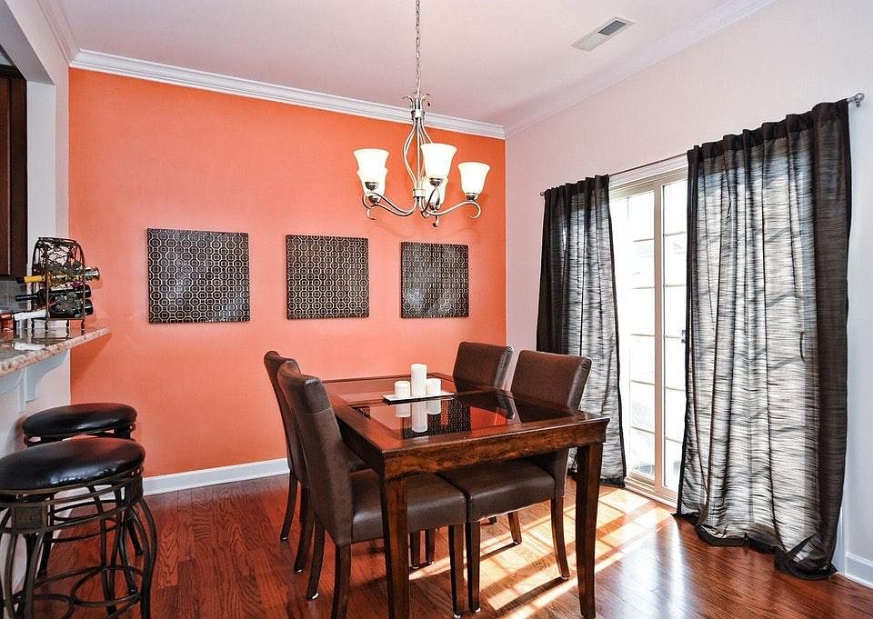 Dining with hardwood flooring throughout