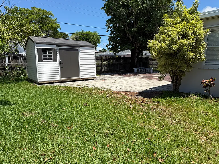 Storage shed and fenced in yard