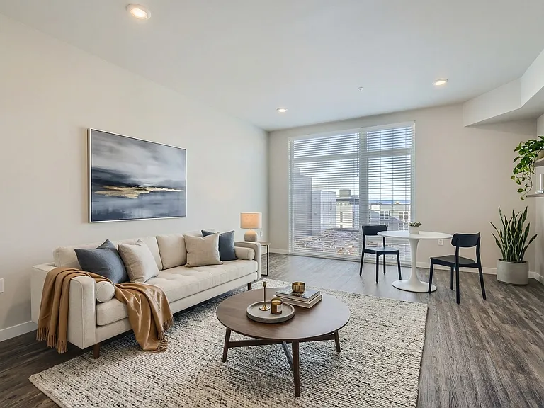 Settle into a bright living room with a dining nook and sweeping city views.