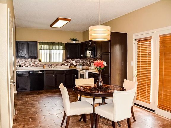 Tile flooring in the eat in kitchen.  Flooring is carried under stairs to the 2 story entryway.