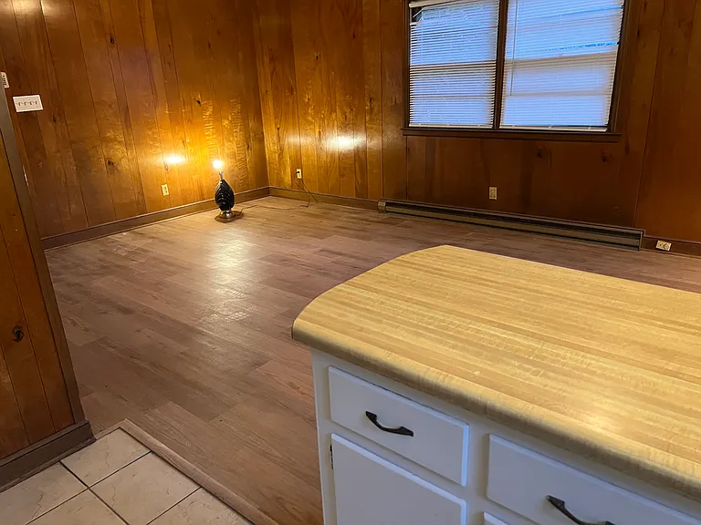 Kitchen view of paneled den.