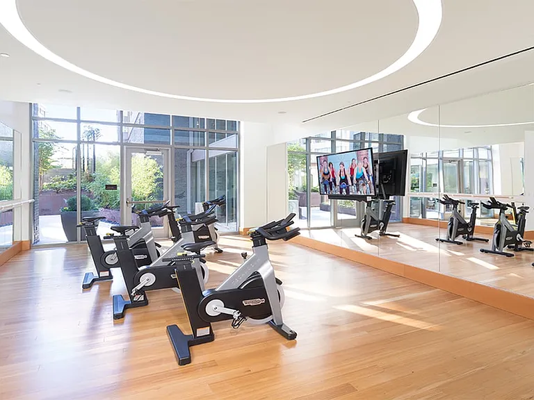 Expansive fitness center featuring a spin room